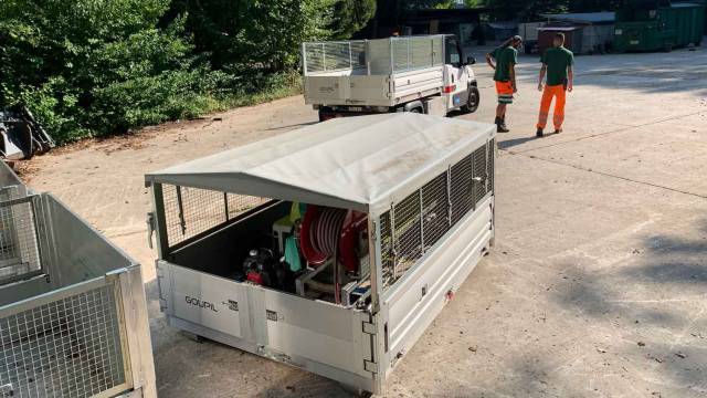 Skip with watering equipment